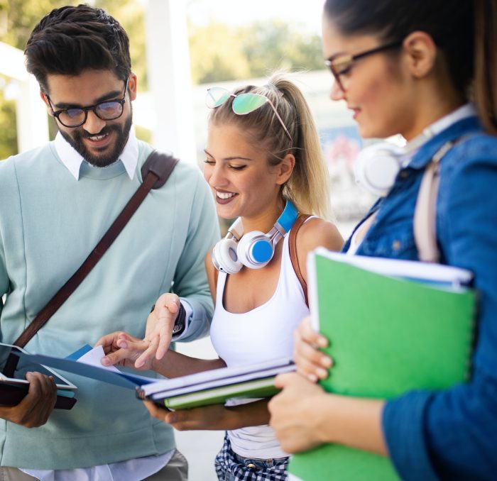 happy-young-university-students-friends-studying-with-books-at-university.jpg